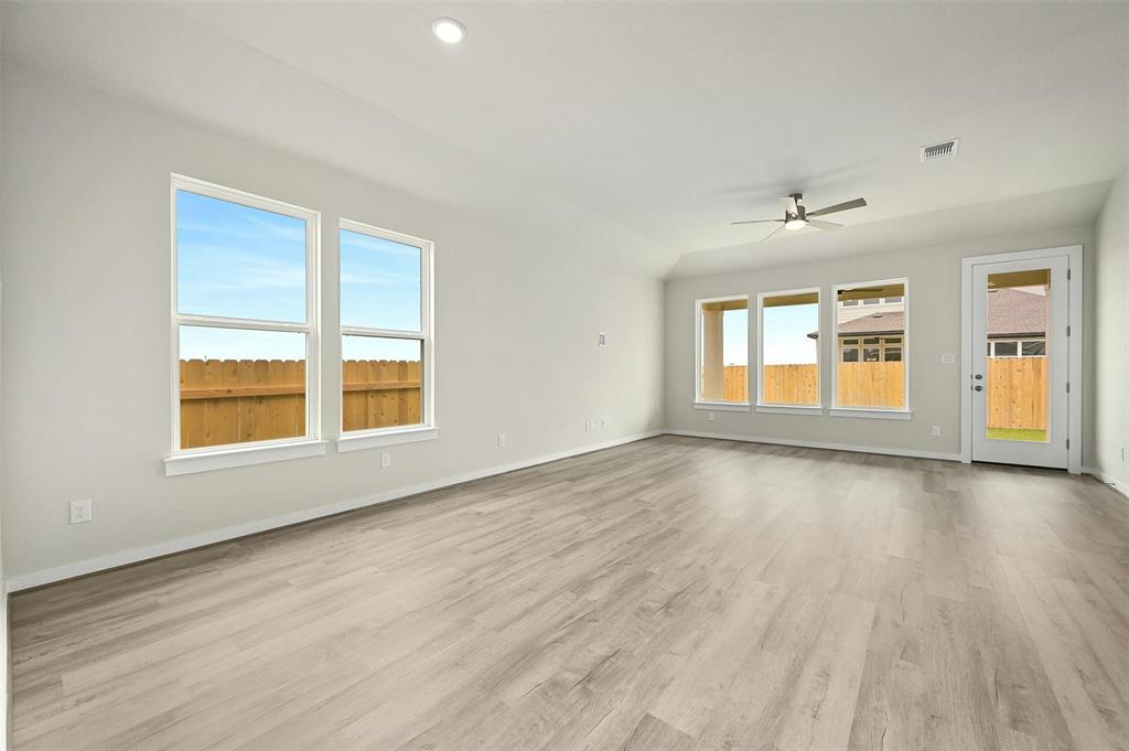 4304 Contrail Lane Round Rock, TX 78665 - Photo 4 of 13 an empty room with wooden floor and windows