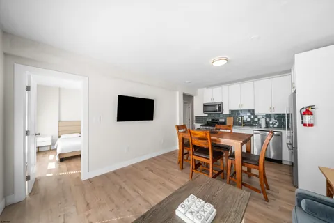 a dining room with furniture and wooden floor