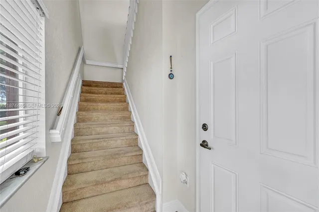 a view of a hallway with stairs