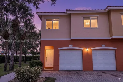 a view of a house with many windows and yard