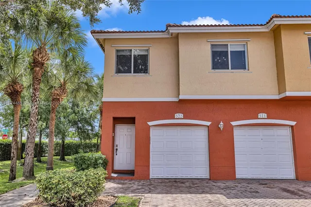 a aerial view of a house with a yard and potted plants