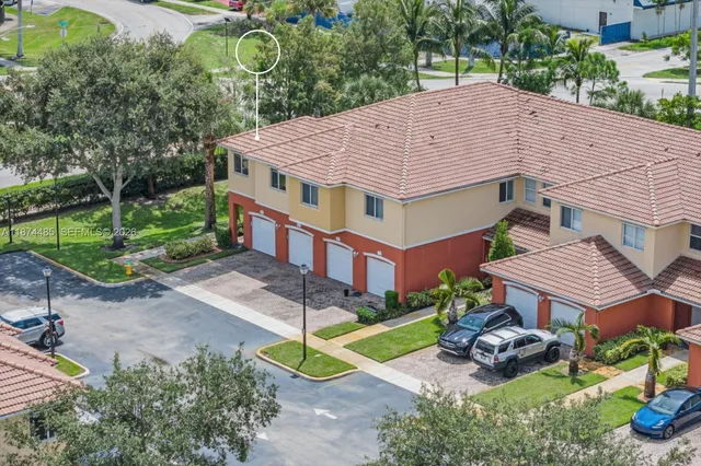 a aerial view of a house with a yard and potted plants