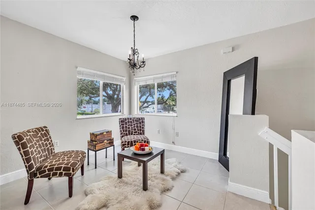 a view of a livingroom with furniture and chandelier