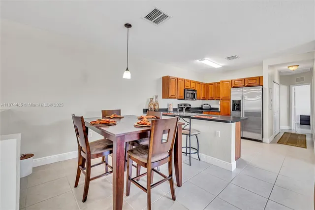 a living room with furniture a flat screen tv and a window