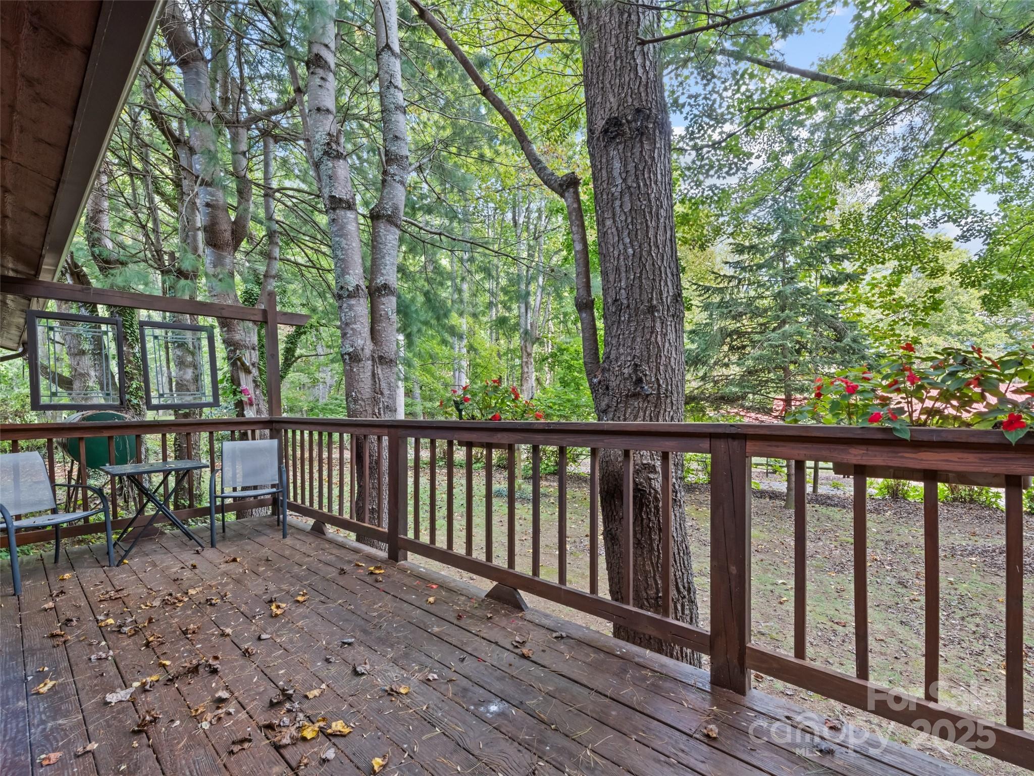 182 Laurel Branch Road Maggie Valley, NC 28751 - Photo 11 of 48 a view of a wooden deck next to a yard