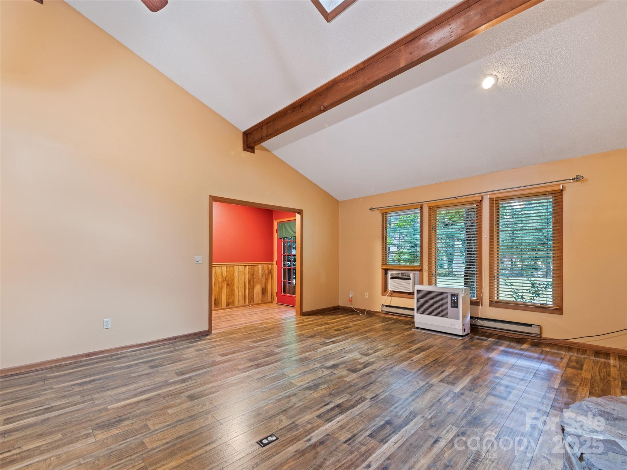 182 Laurel Branch Road Maggie Valley, NC 28751 - Photo 19 of 48 a view of an empty room with wooden floor and a window