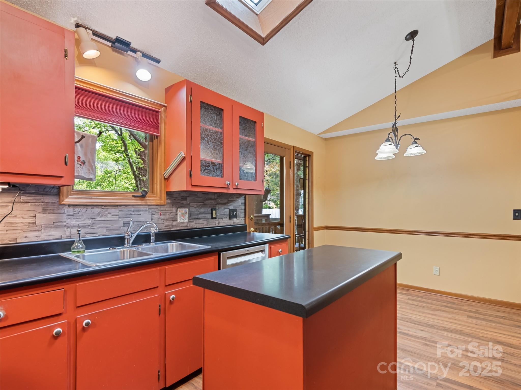 182 Laurel Branch Road Maggie Valley, NC 28751 - Photo 26 of 48 a kitchen with stainless steel appliances granite countertop a sink a counter space and cabinets