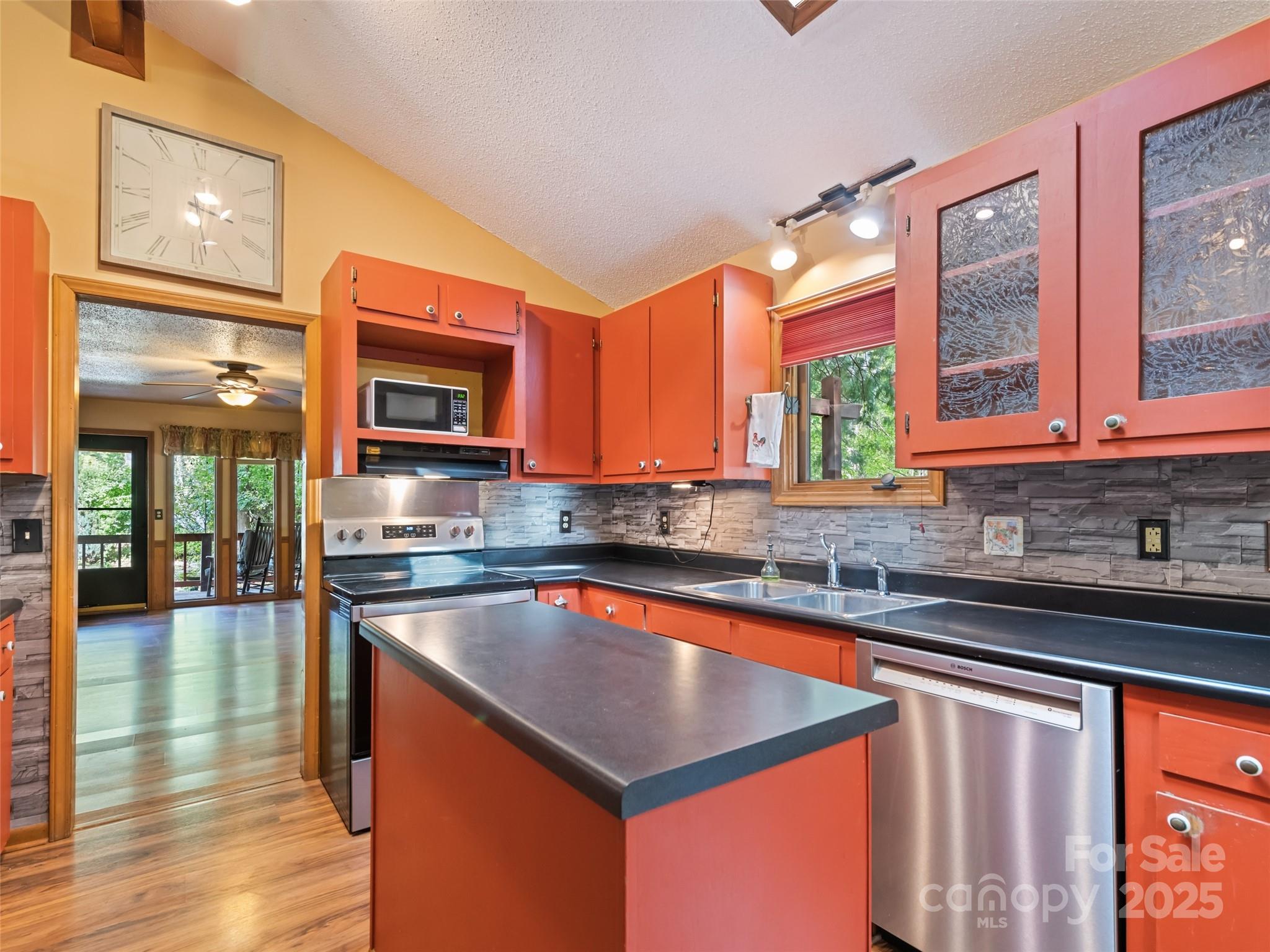182 Laurel Branch Road Maggie Valley, NC 28751 - Photo 29 of 48 a kitchen with stainless steel appliances granite countertop a sink and a microwave