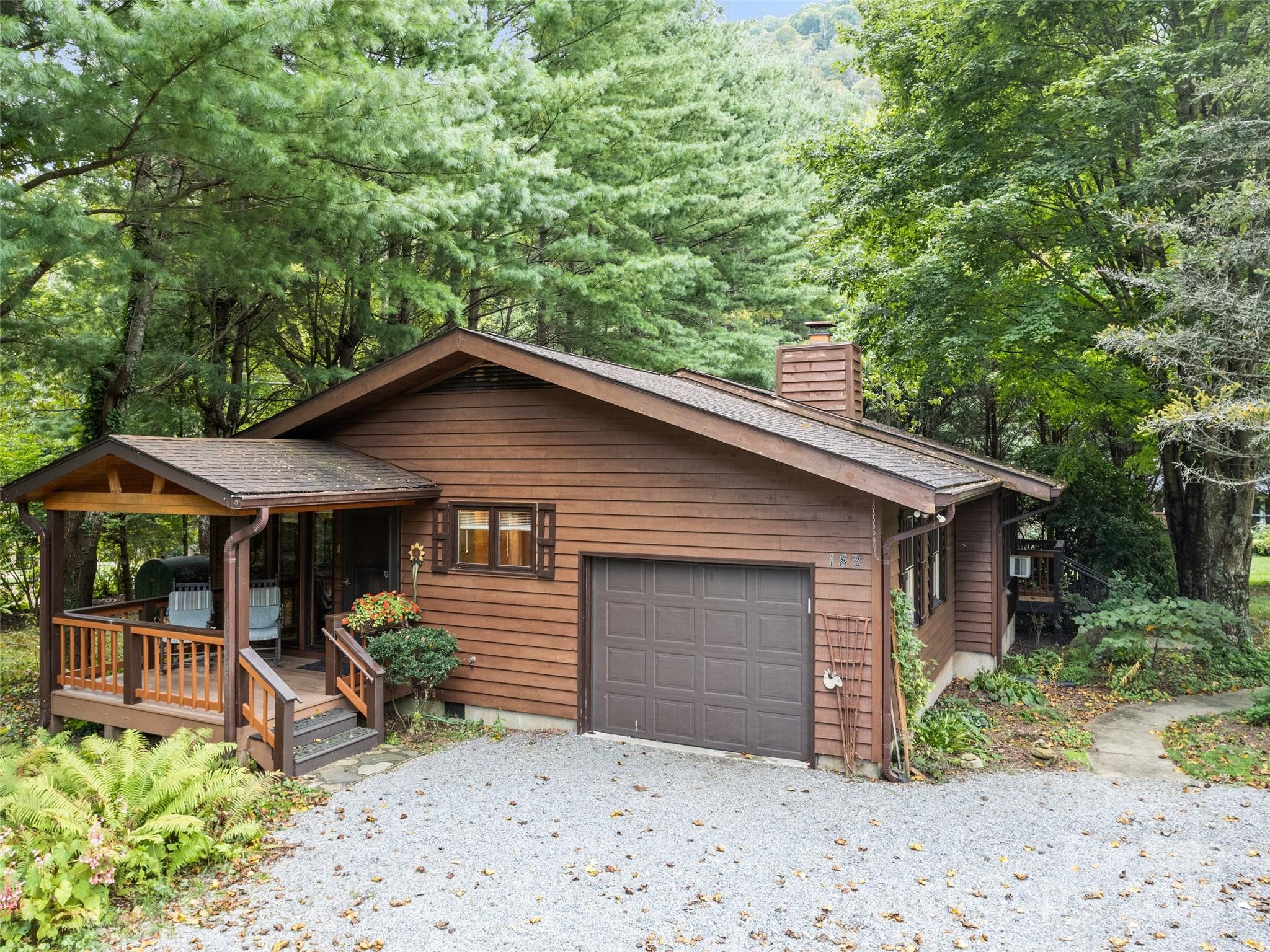 182 Laurel Branch Road Maggie Valley, NC 28751 - Photo 3 of 48 a front view of house with yard and seating area