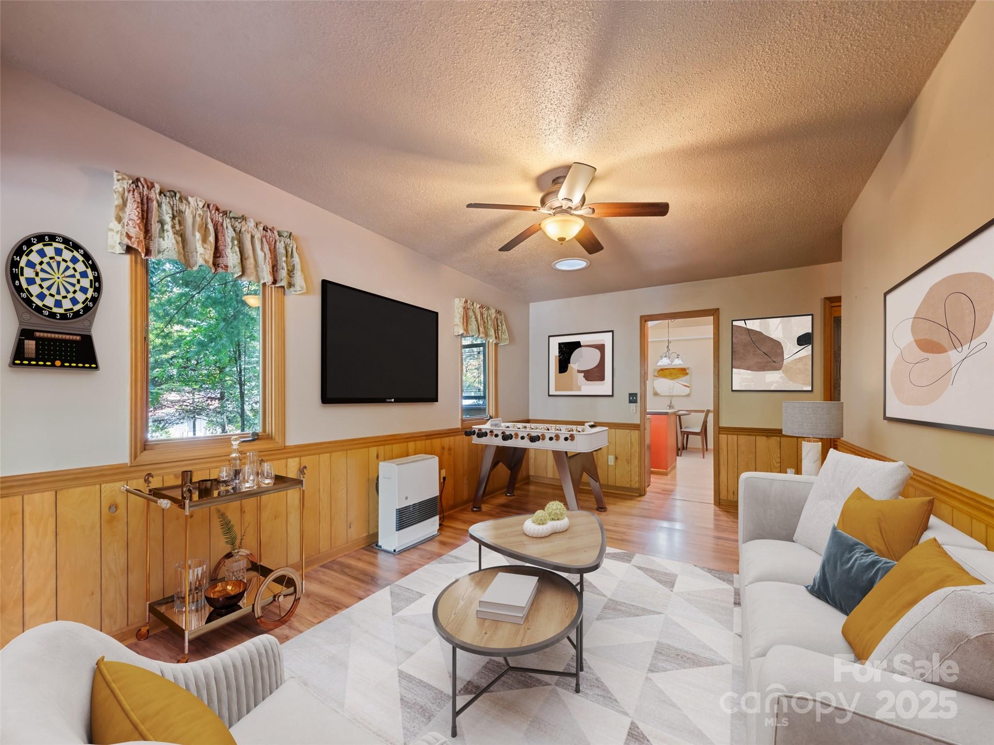 182 Laurel Branch Road Maggie Valley, NC 28751 - Photo 31 of 48 a living room with furniture a flat screen tv and a large window