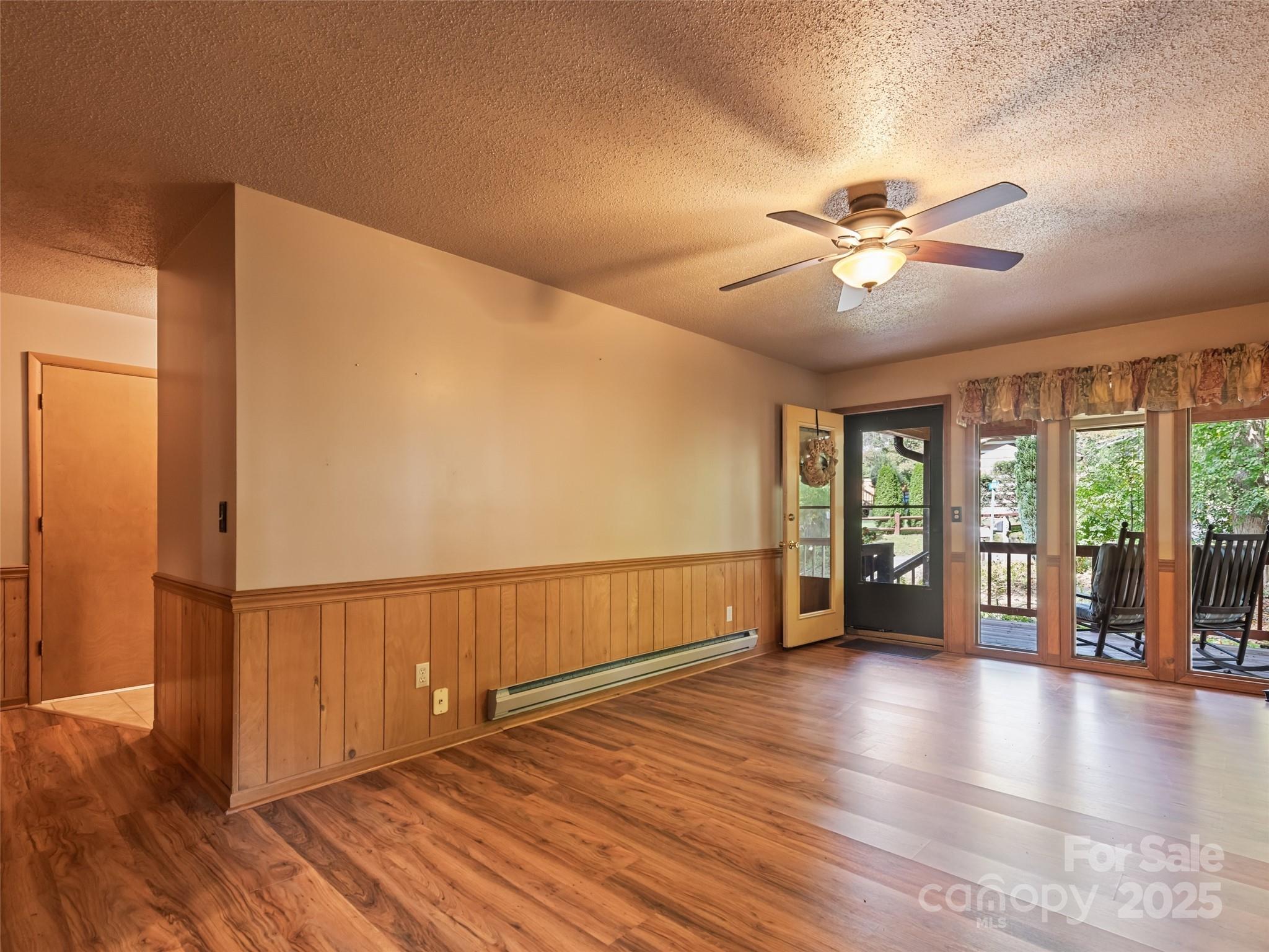 182 Laurel Branch Road Maggie Valley, NC 28751 - Photo 35 of 48 a view of an empty room with a window and wooden floor
