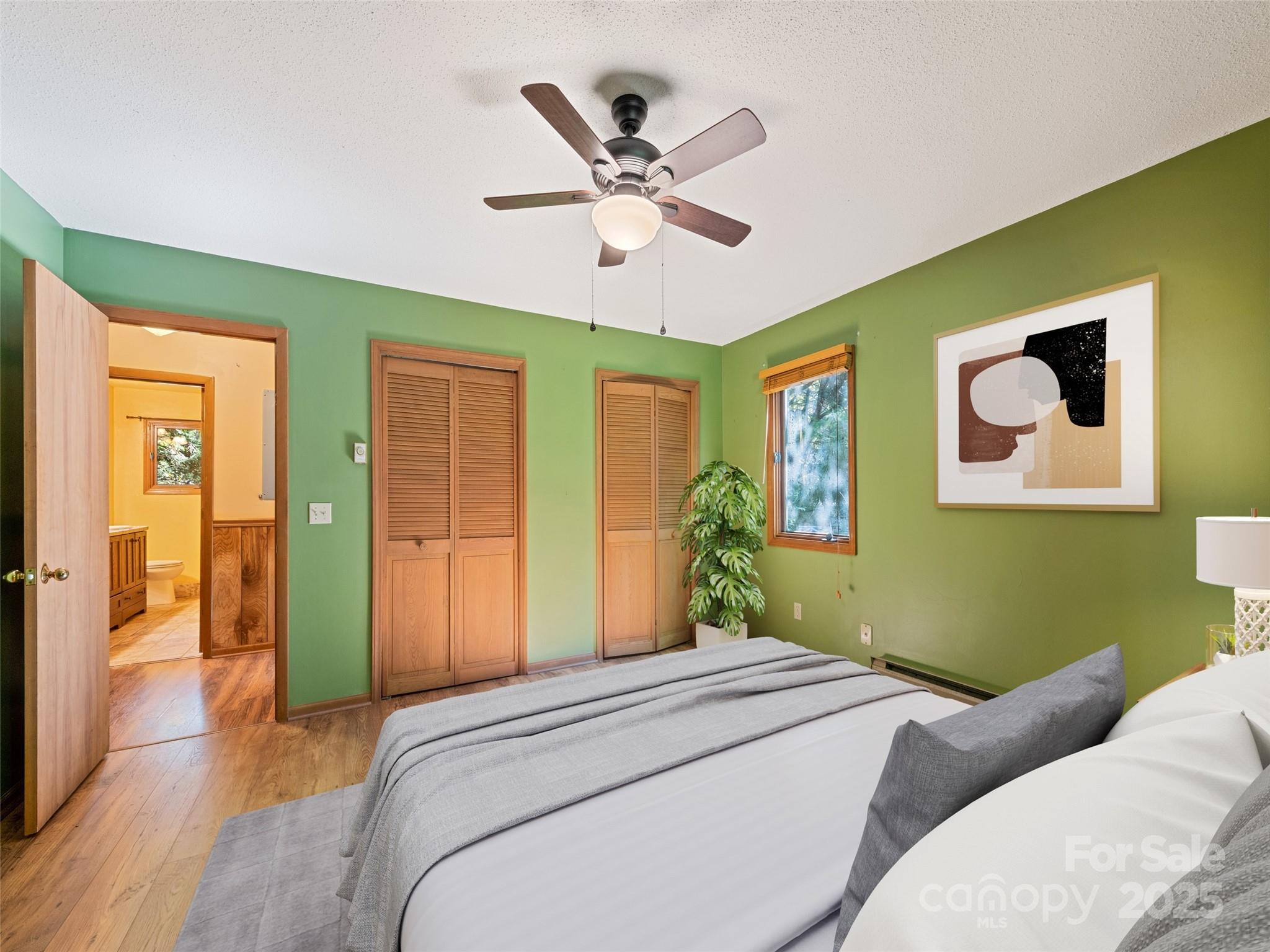 182 Laurel Branch Road Maggie Valley, NC 28751 - Photo 38 of 48 a bedroom with a bed and a chandelier