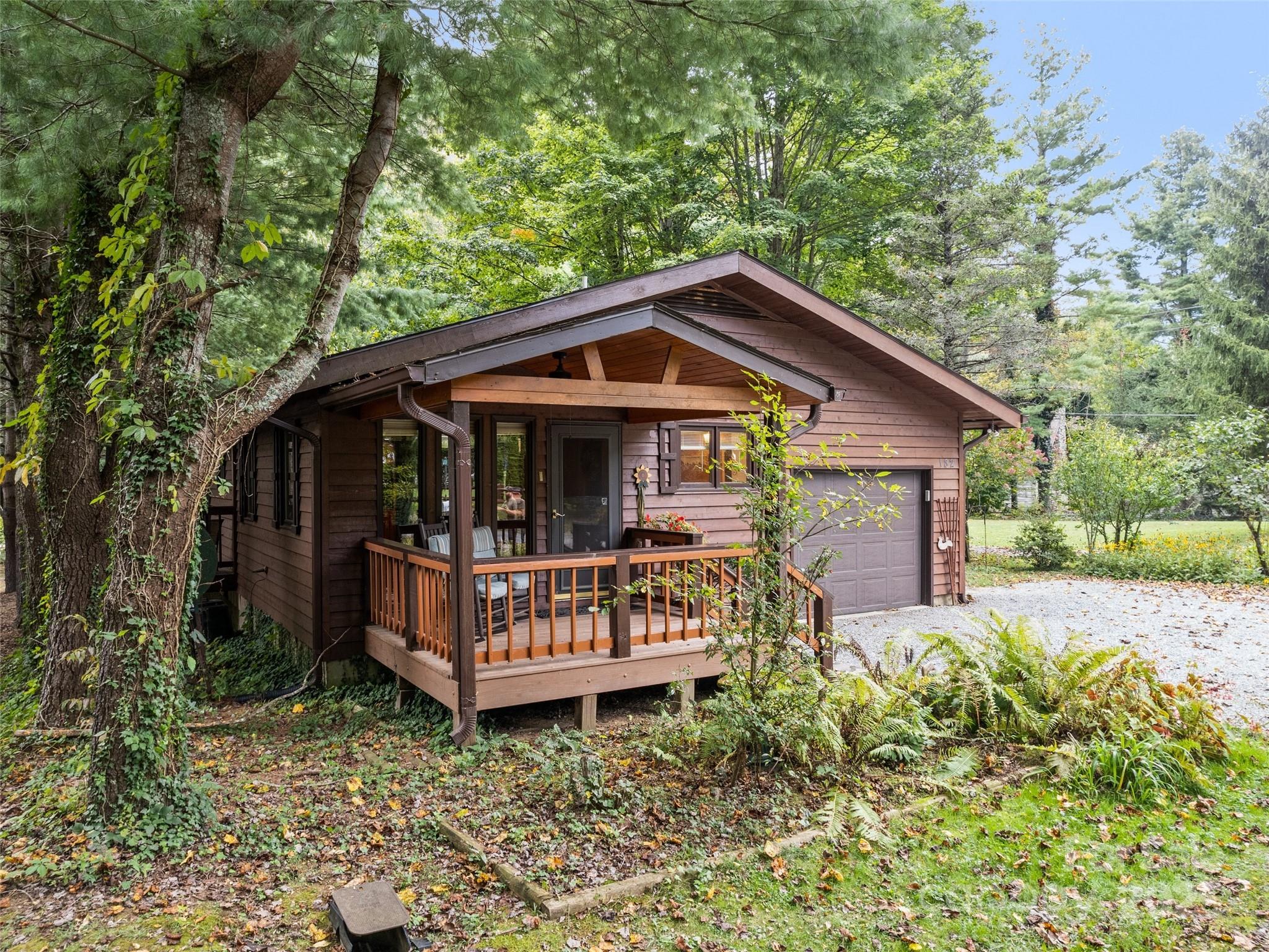 182 Laurel Branch Road Maggie Valley, NC 28751 - Photo 4 of 48 a front view of a house with garden