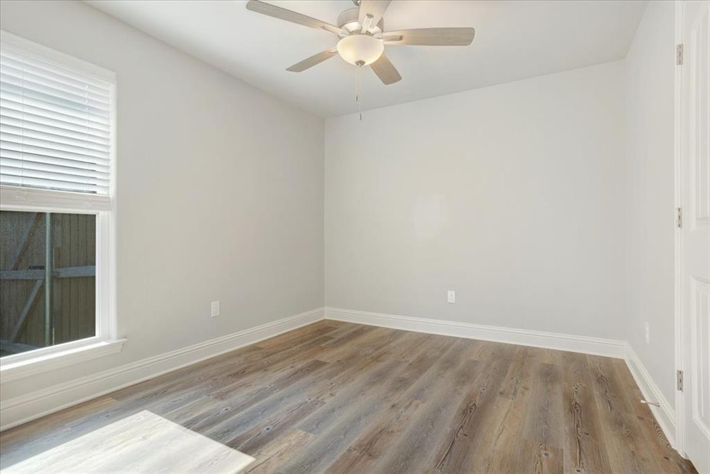 2111 Wyldewood Way Sherman, TX 75092 - Photo 19 of 33 wooden floor in an empty room with a window