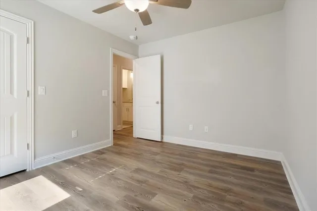 a bathroom with a granite countertop sink a toilet and shower