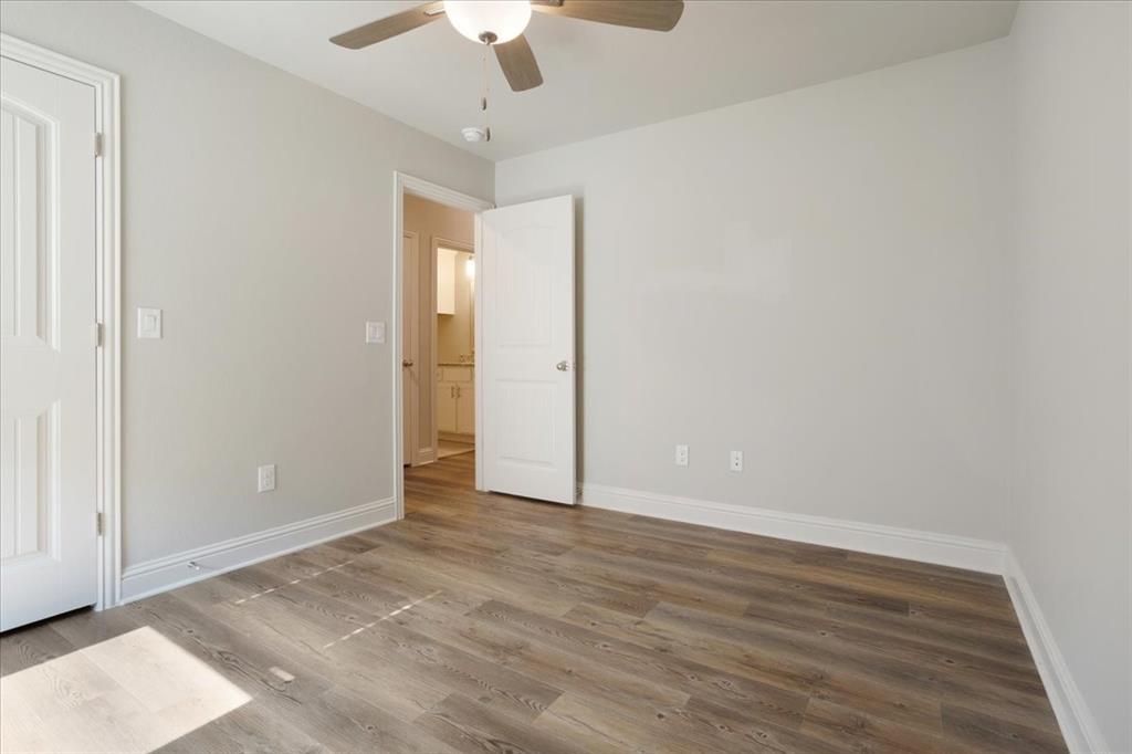 2111 Wyldewood Way Sherman, TX 75092 - Photo 22 of 33 an empty room with wooden floor fan and window
