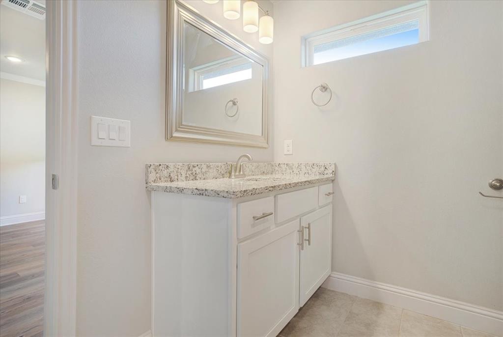 2111 Wyldewood Way Sherman, TX 75092 - Photo 23 of 33 a bathroom with a granite countertop sink and a mirror