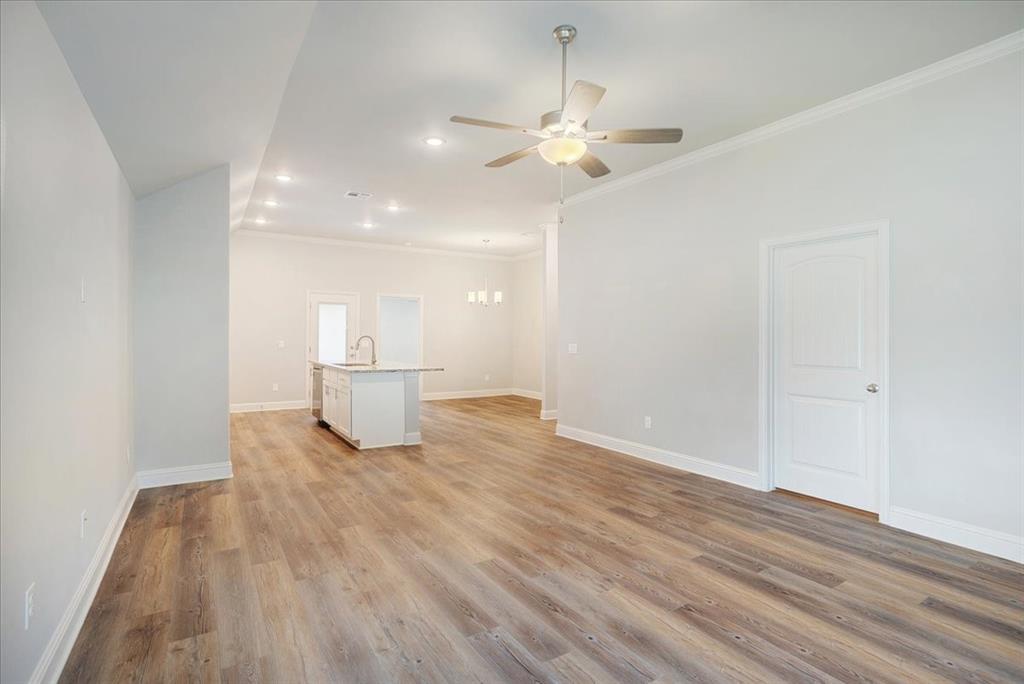 2111 Wyldewood Way Sherman, TX 75092 - Photo 7 of 33 a view of a livingroom with a chandelier fan and wooden floor