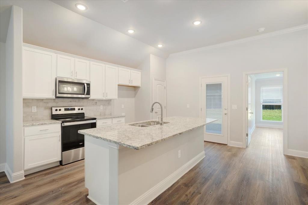 2111 Wyldewood Way Sherman, TX 75092 - Photo 9 of 33 a kitchen with a sink microwave and stove