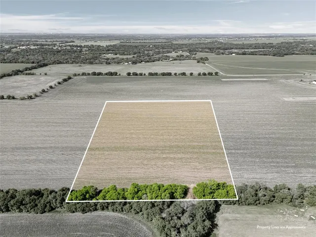 a view of a terrace with lawn chairs