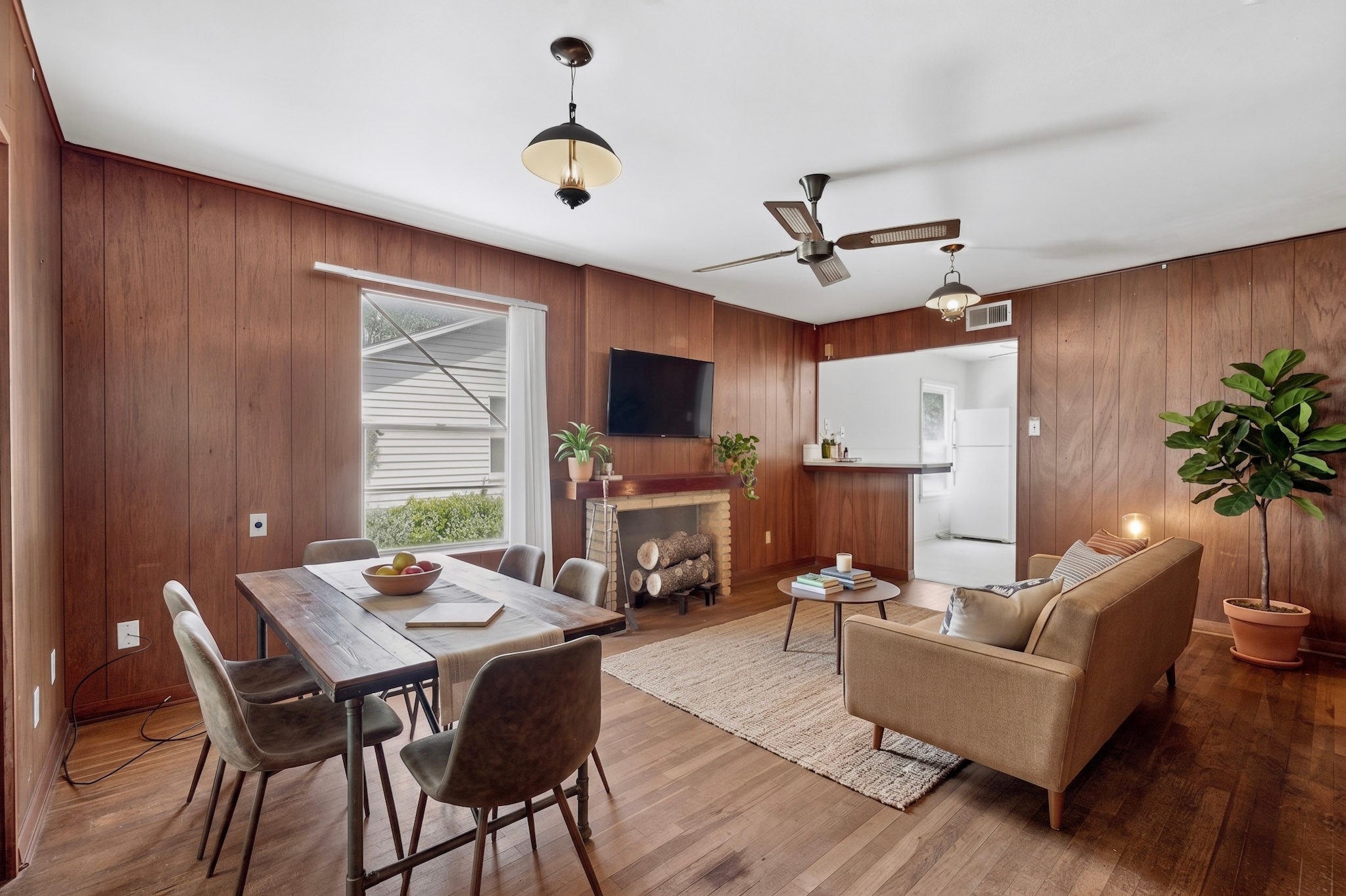 4703 Leslie Avenue Austin, TX 78721 - Photo 10 of 34 Hardwood floors and paneling create a warm and inviting living space, perfect for entertaining.