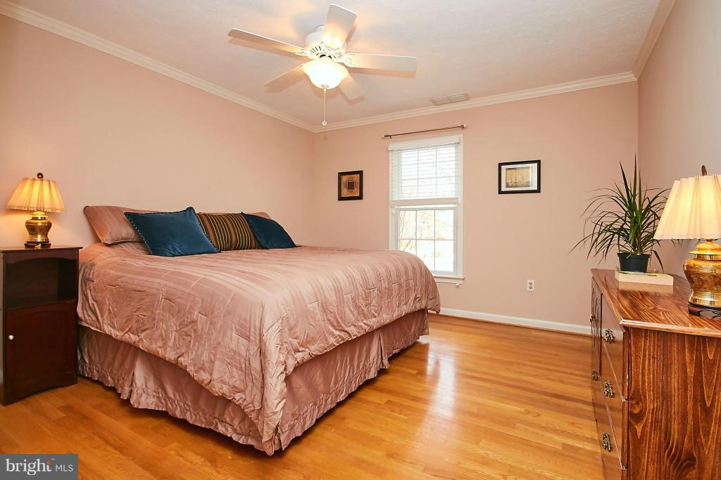 2840 Rifle Ridge Road Oakton, VA 22124 - Photo 22 of 30 a bedroom with a bed and a chandelier
