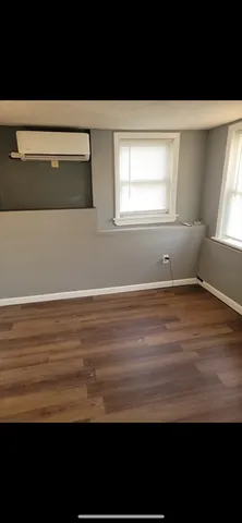 a view of room with window and hardwood floor
