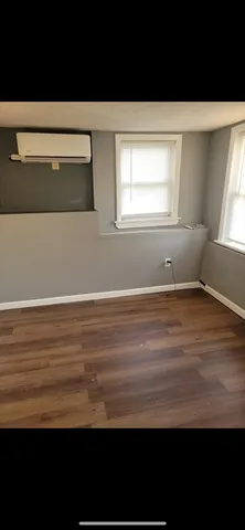 a view of room with window and hardwood floor