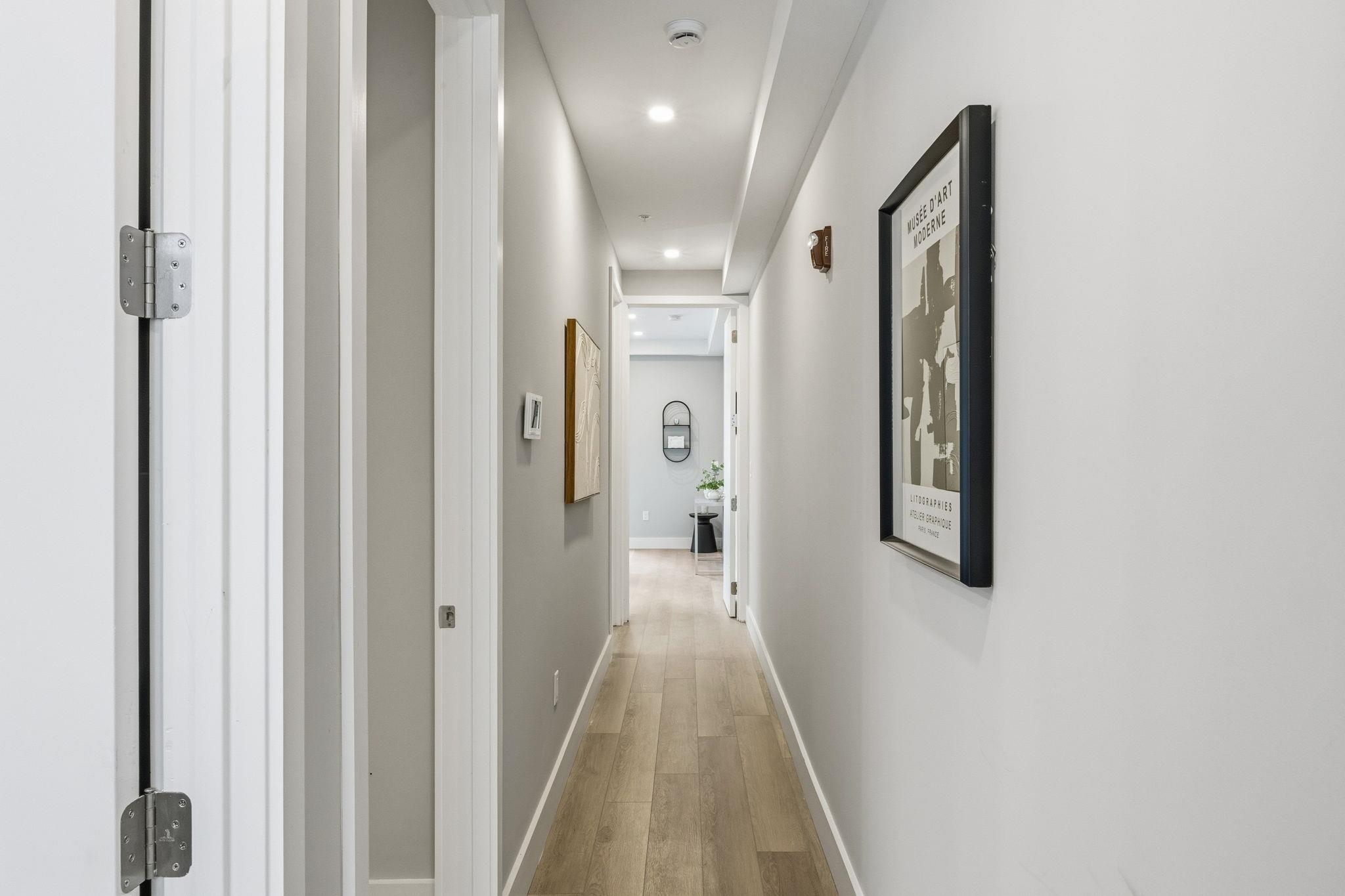 77 Van Reypen Street, Unit 3 Jersey City, NJ 07306 - Photo 3 of 23 a view of a hallway with wooden floor and closet area