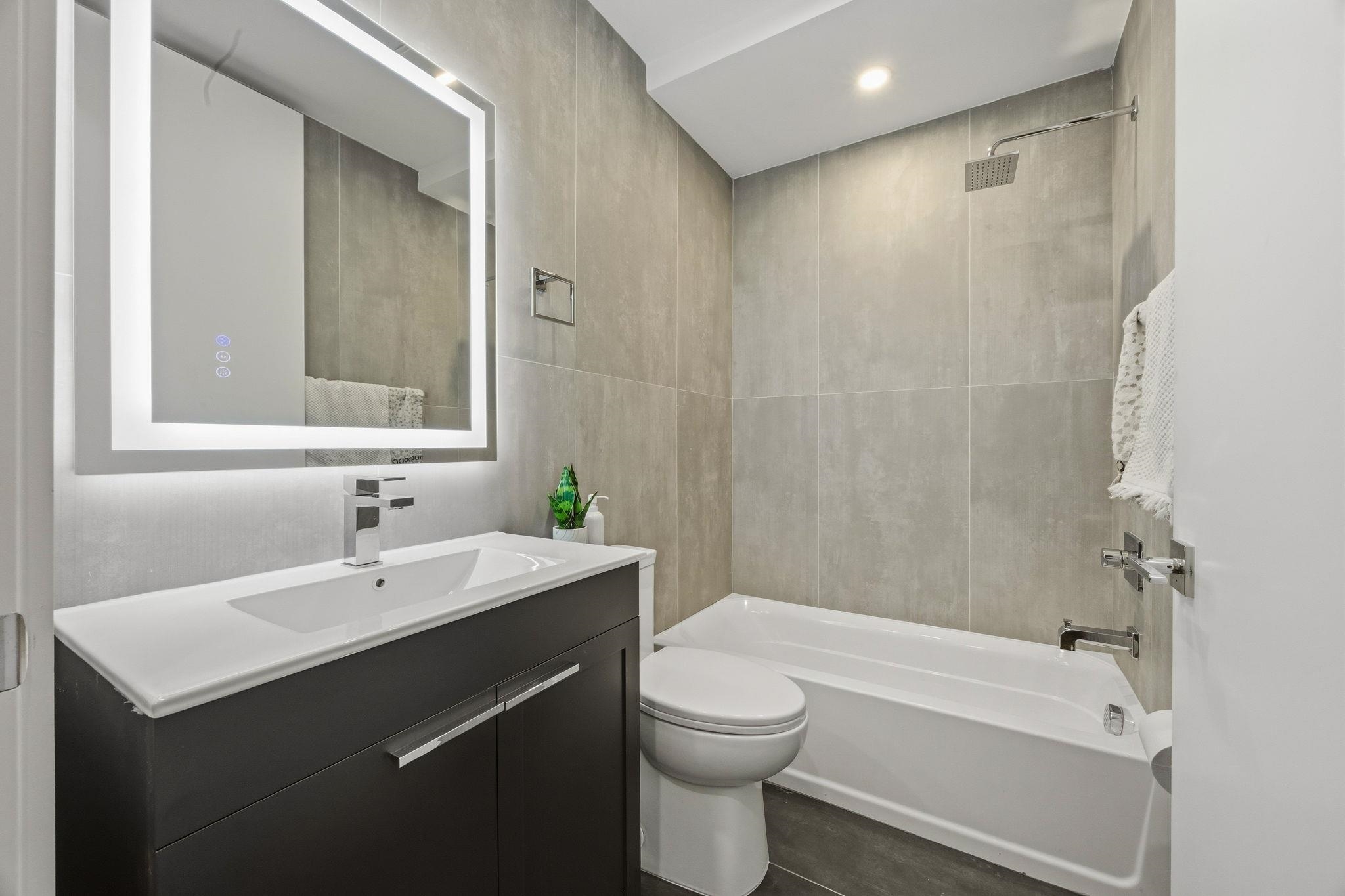 77 Van Reypen Street, Unit 3 Jersey City, NJ 07306 - Photo 6 of 23 a bathroom with a sink a toilet and shower