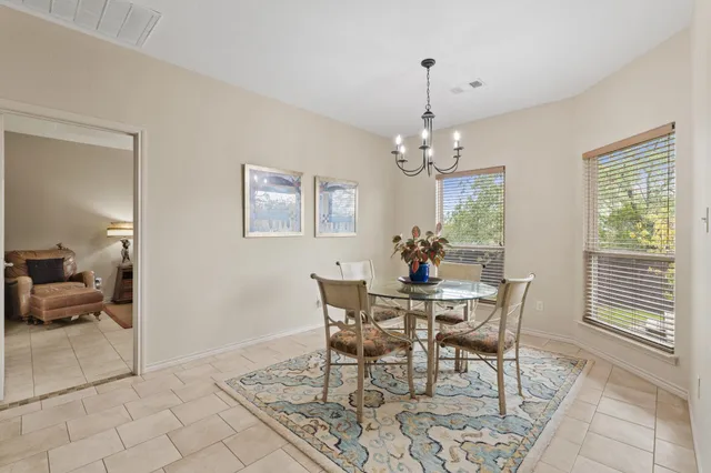 a view of a dining room with furniture and chandelier