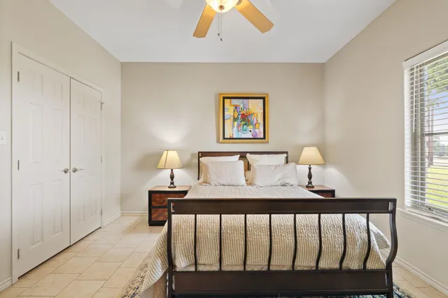 a bedroom with a bed and a window