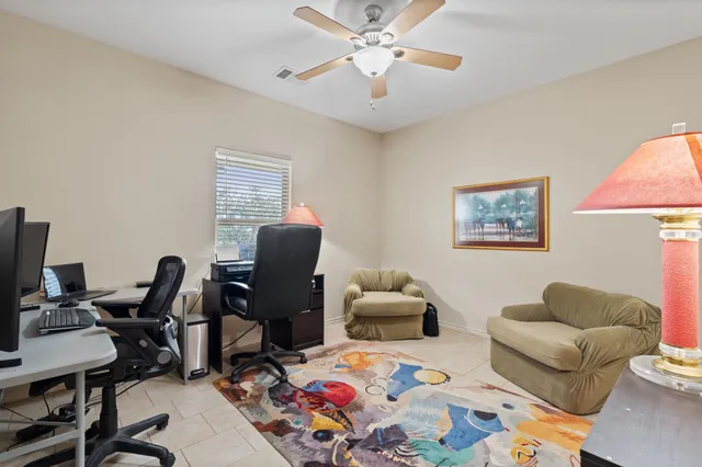 a view of a workspace with lounge chair and a couch