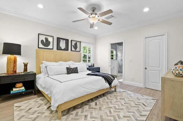 a bedroom with a bed and a lamp with the dresser