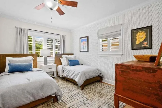 a bedroom with two beds and a chandelier