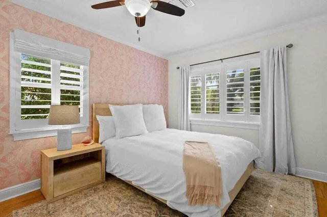 a bedroom with a bed and a window