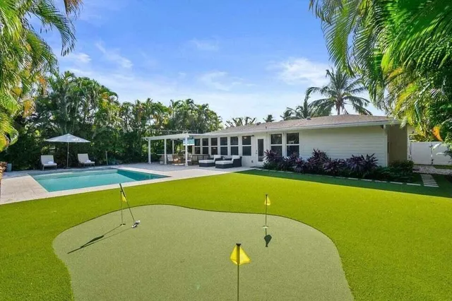 a view of a house with swimming pool and porch
