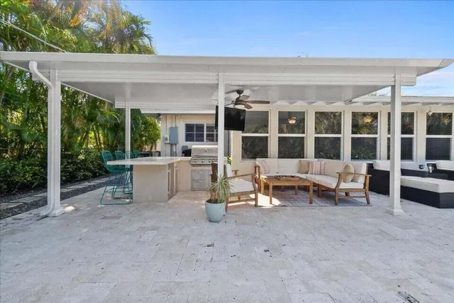 a view of a patio with table and chairs with wooden floor and fence