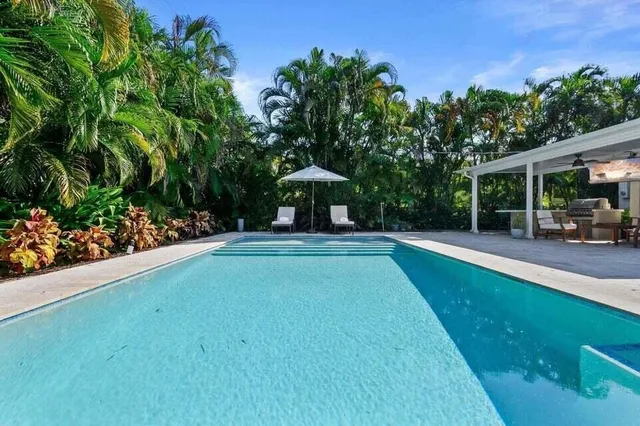 a view of a swimming pool with a patio