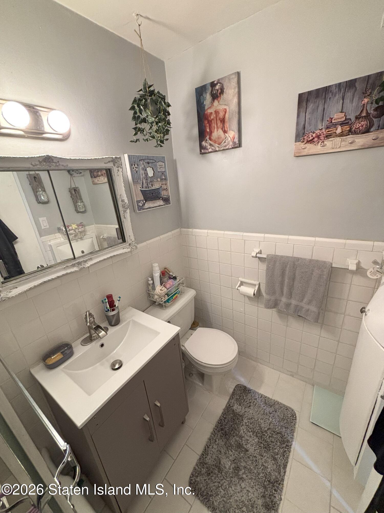 2483 West 16th Street, Unit 15F Brooklyn, NY 11214 - Photo 15 of 25 a bathroom with a sink toilet and mirror