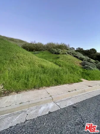 a view of a road with a field