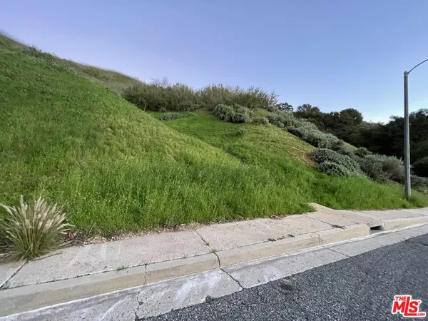 a view of a road with a garden