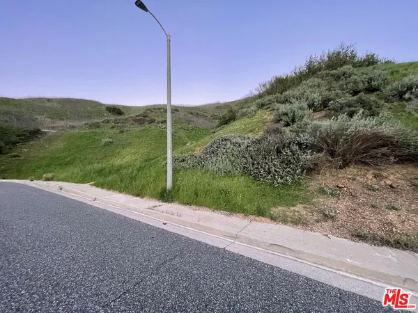 a view of a road with a big yard
