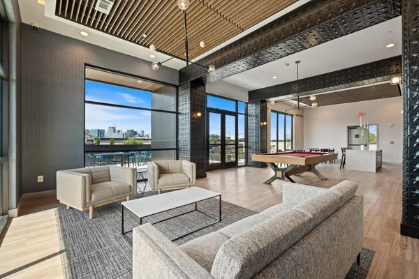 a living room with furniture and a large window