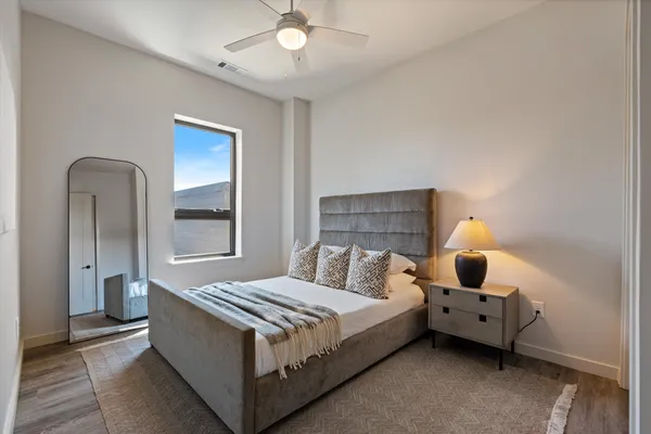 a bedroom with a bed and a chandelier
