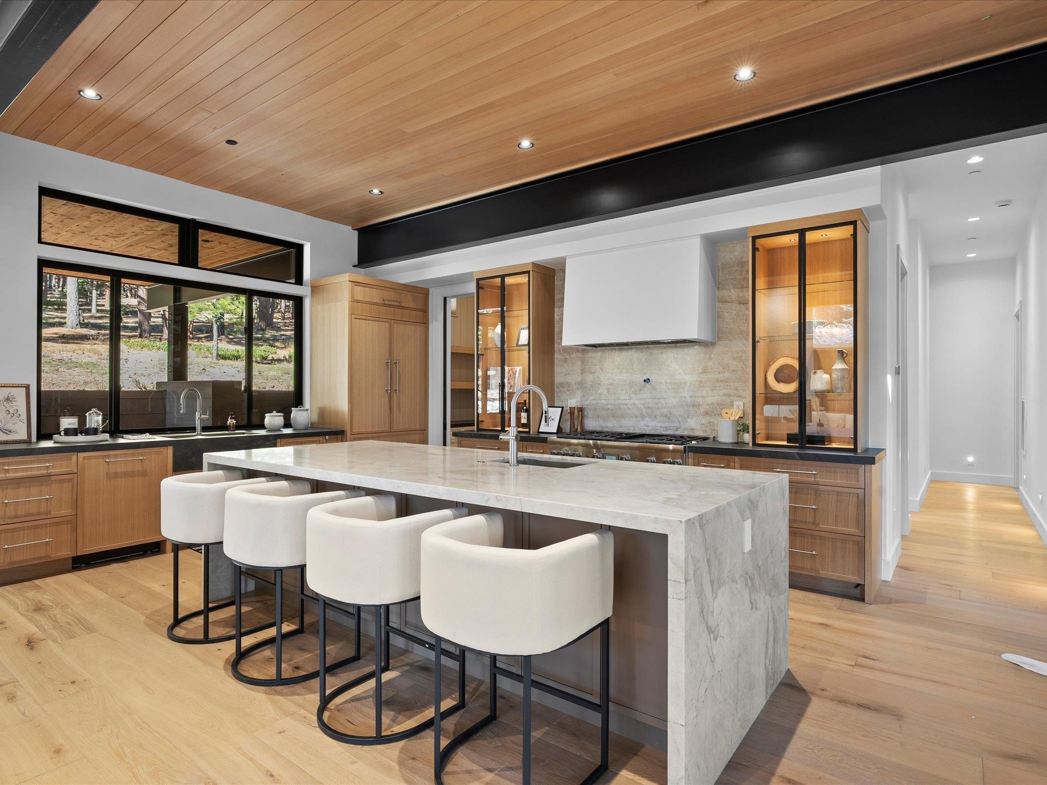 11630 Bottcher Loop Truckee, CA 96161 - Photo 11 of 28 a large kitchen with kitchen island a large window a sink and chairs