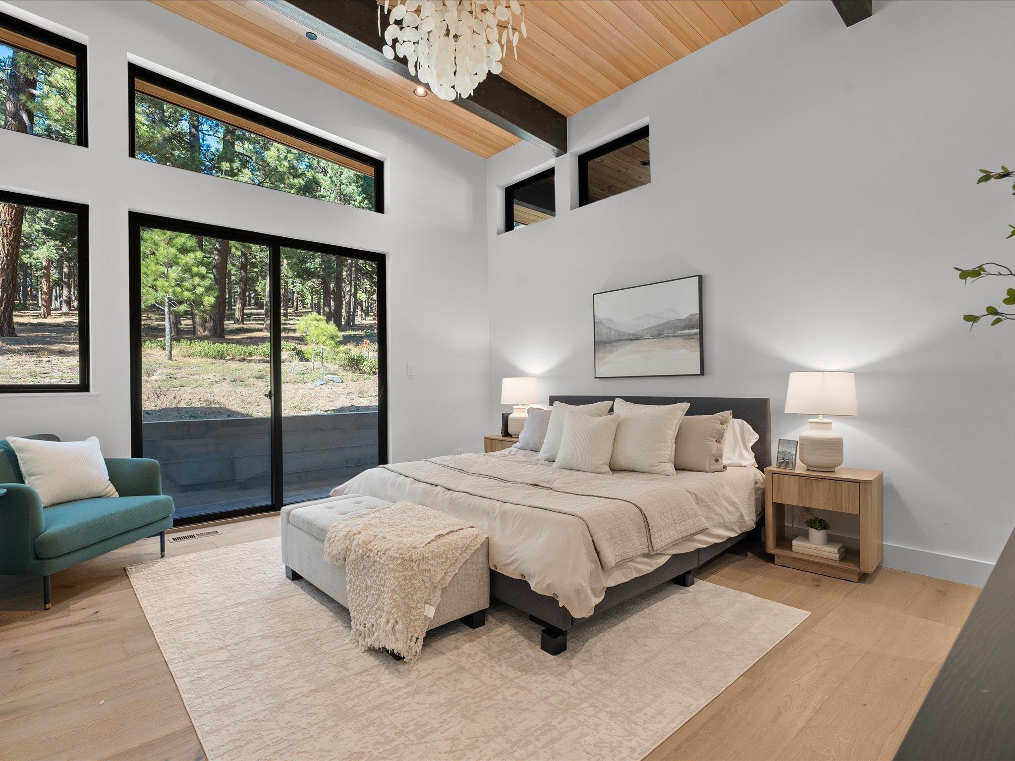 11630 Bottcher Loop Truckee, CA 96161 - Photo 15 of 28 a spacious bedroom with a bed couch and a large window