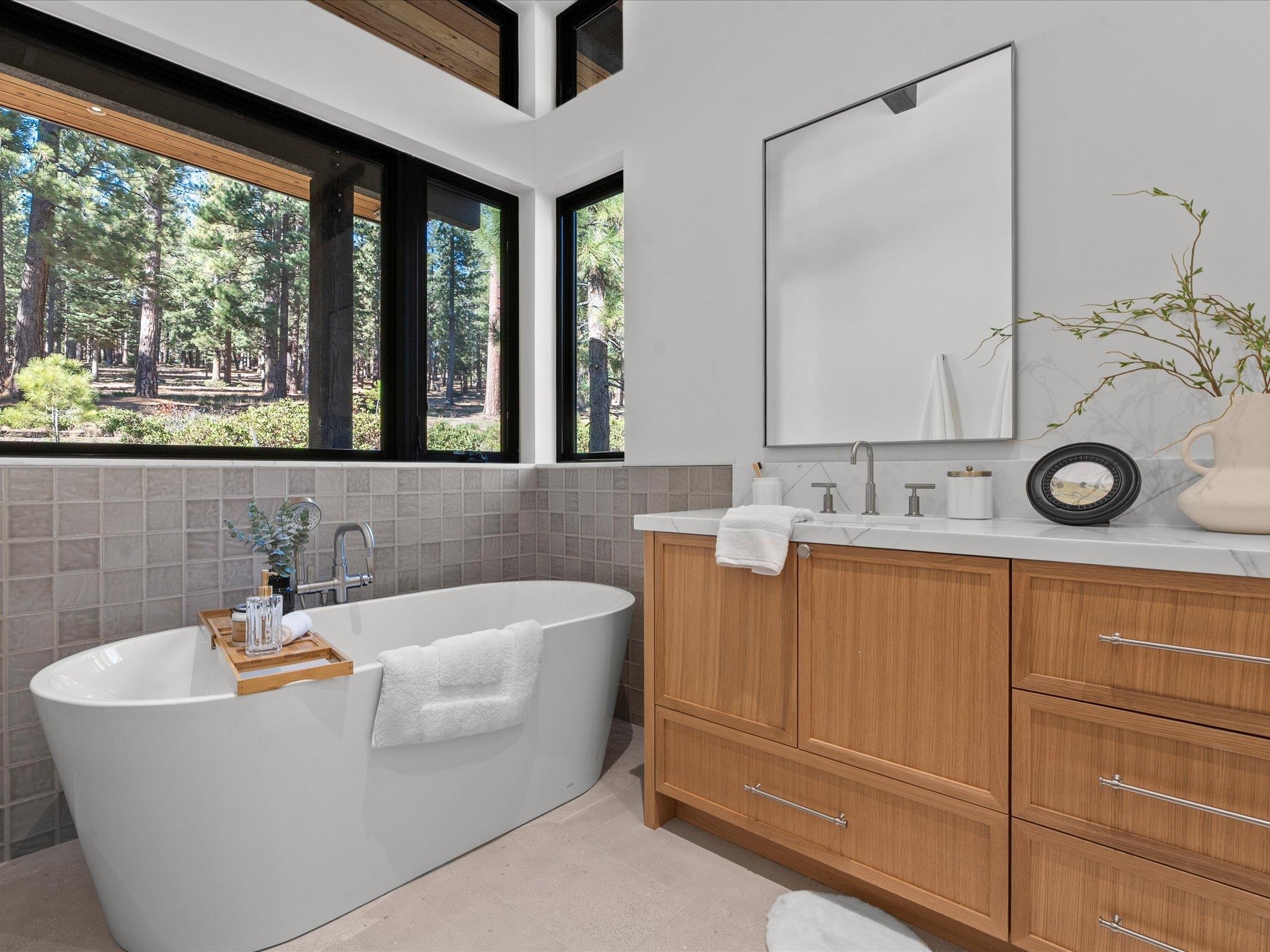 11630 Bottcher Loop Truckee, CA 96161 - Photo 18 of 28 a bathroom with a bathtub a sink and a window