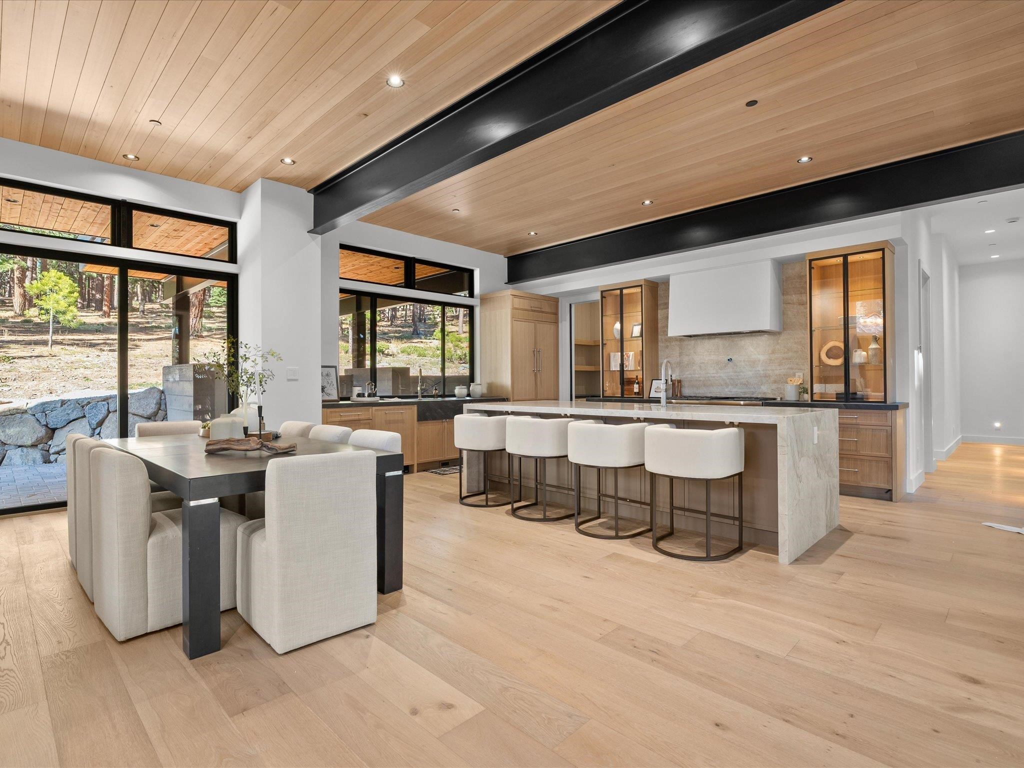 11630 Bottcher Loop Truckee, CA 96161 - Photo 5 of 28 a living room with couches a dining table chairs and a large window