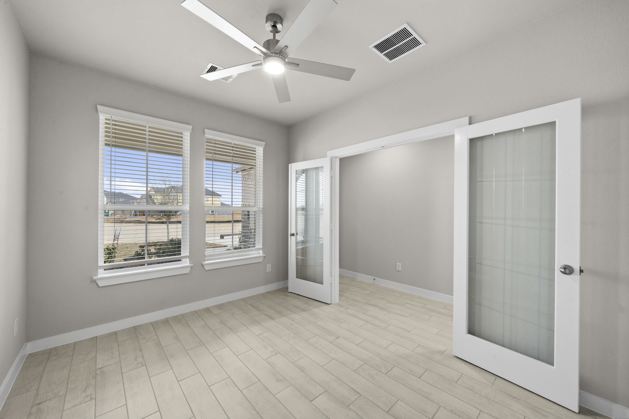 4017 Sun Burst Lane Brookshire, TX 77423 - Photo 11 of 49 a view of an empty room with a window and wooden floor